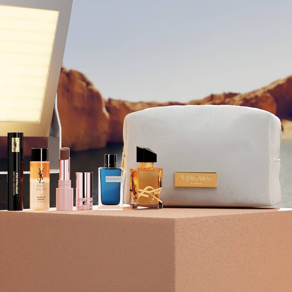 YSL Beauty-Set mit Miniprodukten und weißer Kosmetiktasche.