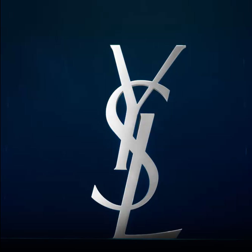 A sleek, stylized silver logo of "YSL" stacked vertically against a dark blue background.