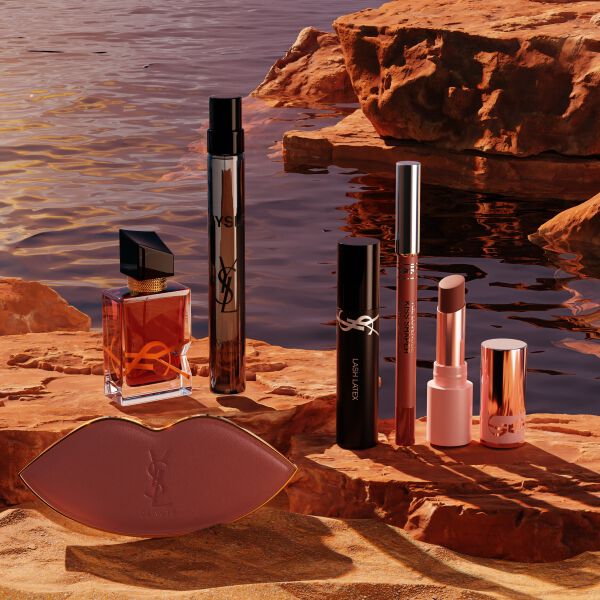 YSL Beauty-Set mit Miniprodukten und weißer Kosmetiktasche.